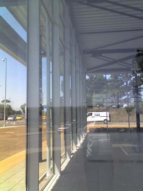 Glazed shopfront facade beneath a steel canopy
