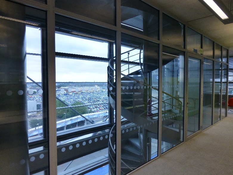 Glazed fire screen alongside a spiral staircase